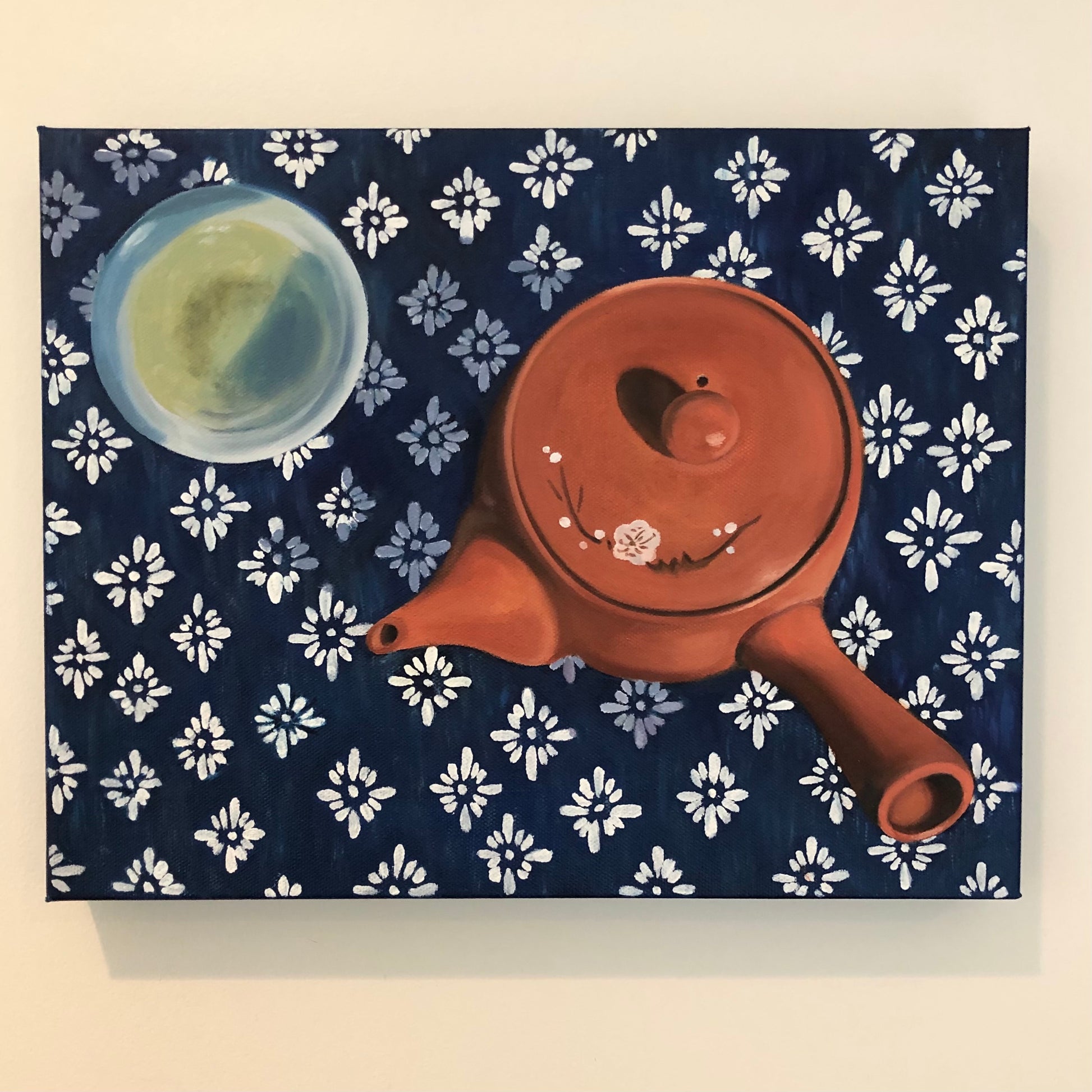 still life oil painting overhead view of traditional terra cotta Japanese teapot and cup of green tea on an indigo shibori tablecloth
