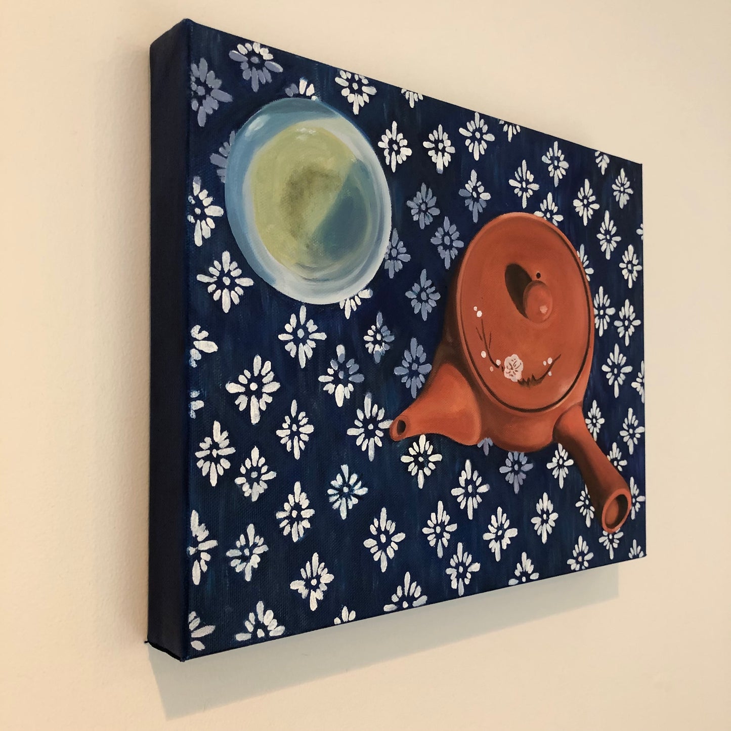 still life oil painting side view of traditional terra cotta Japanese teapot and cup of green tea on an indigo shibori tablecloth