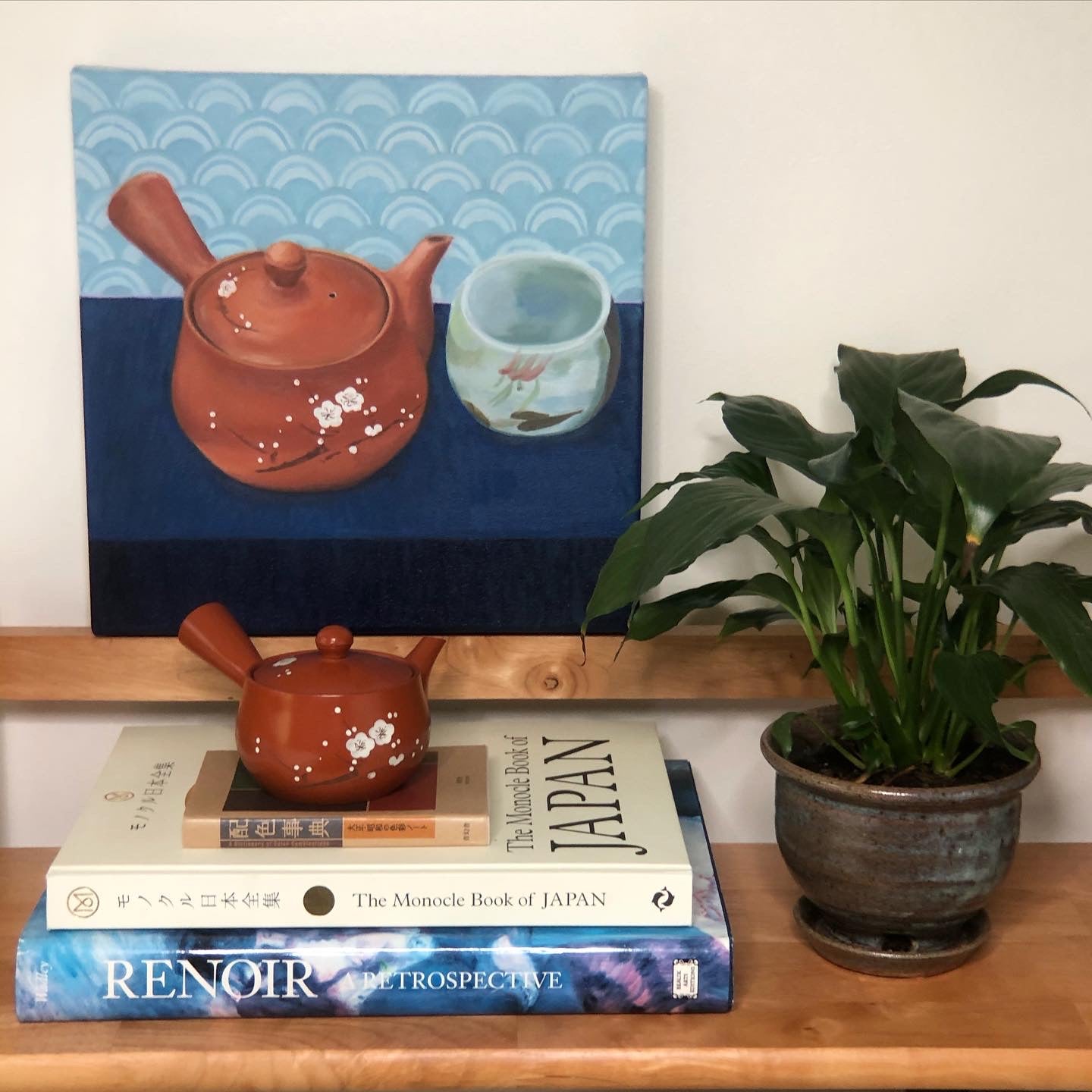 still life oil painting of terra cotta traditional Japanese teapot with painted sakura branch and blossoms next to hand-painted teacup, interior design styled